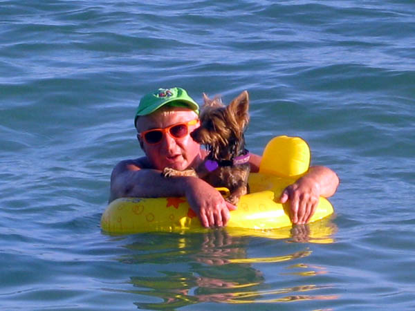 Man and dog afloat in Key West, Florida, USA
